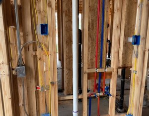 Jobsite photo — framing and plumbing rough-in